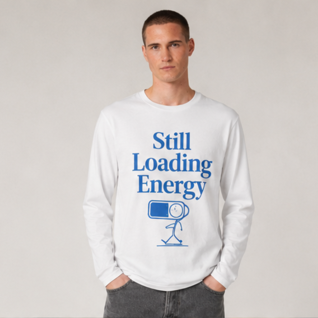 männliches modell steht im studio. Weißes Longsleeve aus Bio-Baumwolle mit ‚Still Loading Energy‘ Design, frontal